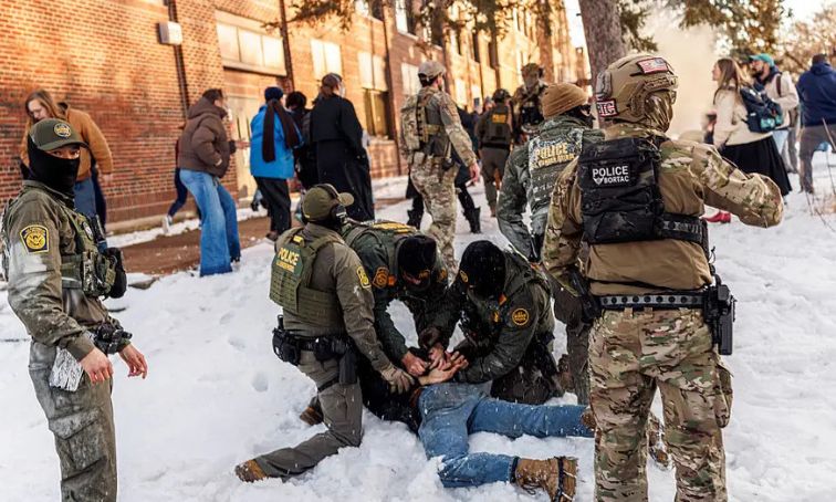 US Border Patrol agents detain someone near Roosevelt High School during dismissal on January 7, 2026, as federal immigration enforcement actions sparked protests across Minneapolis.